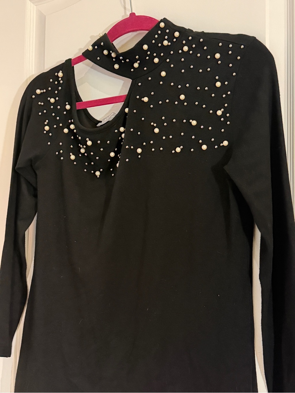 Off-the-Shoulder Black Sweater with Pearl Embellishments